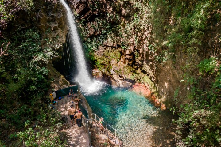 a waterfall surrounded by trees