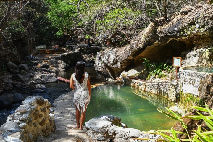 a person standing next to a waterfall