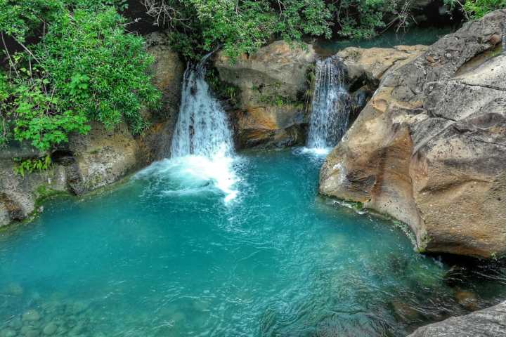 a large waterfall and a pool of water