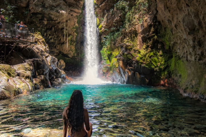 a person standing next to a waterfall